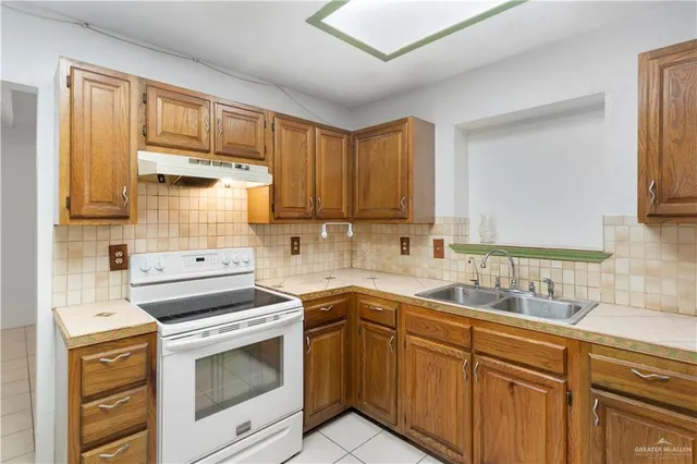 a kitchen with a sink stove and cabinets