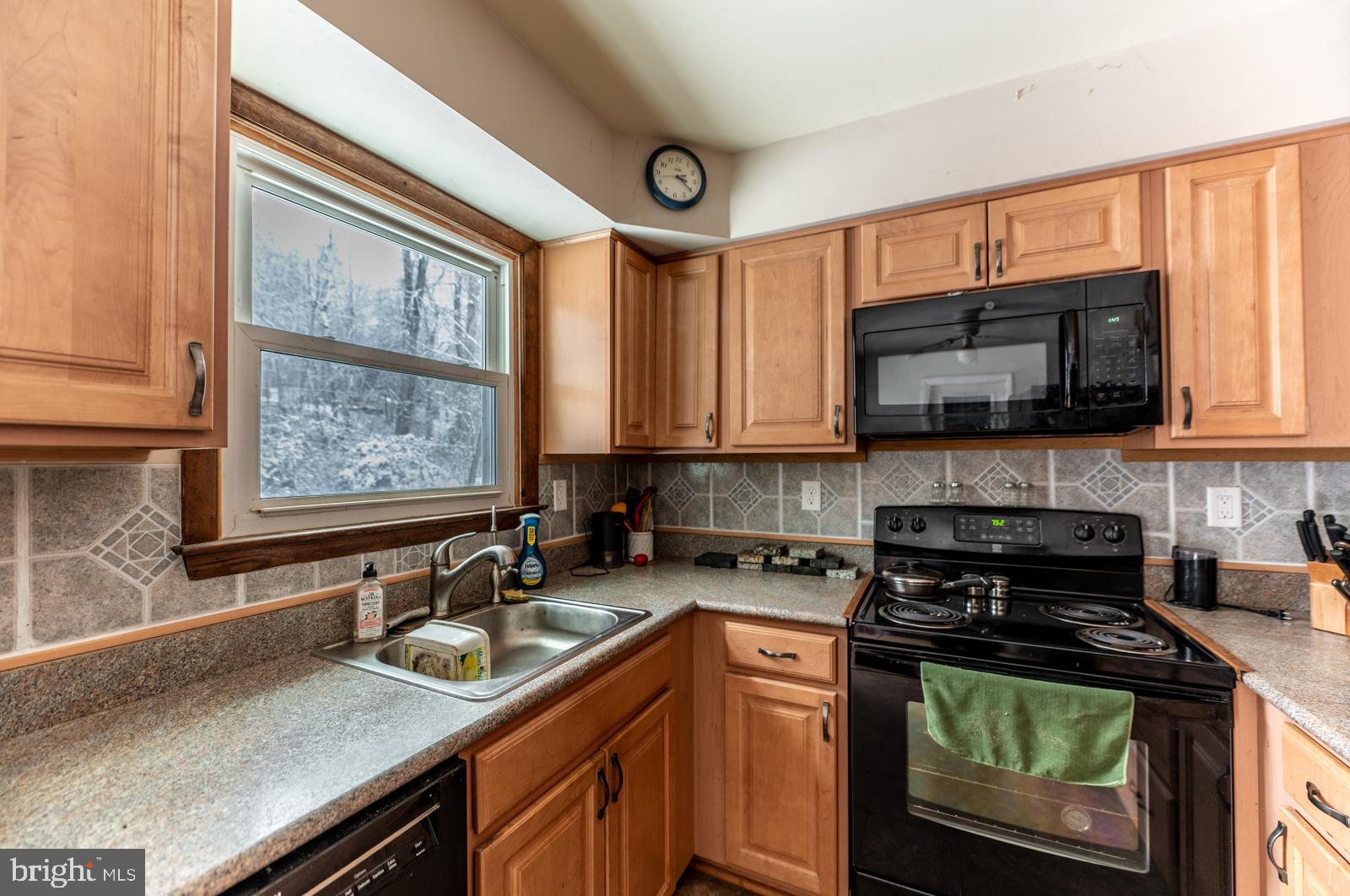 948 Quarry Road Gap, PA 17527 - Photo 11 of 34 a kitchen with stainless steel appliances a stove sink microwave and cabinets