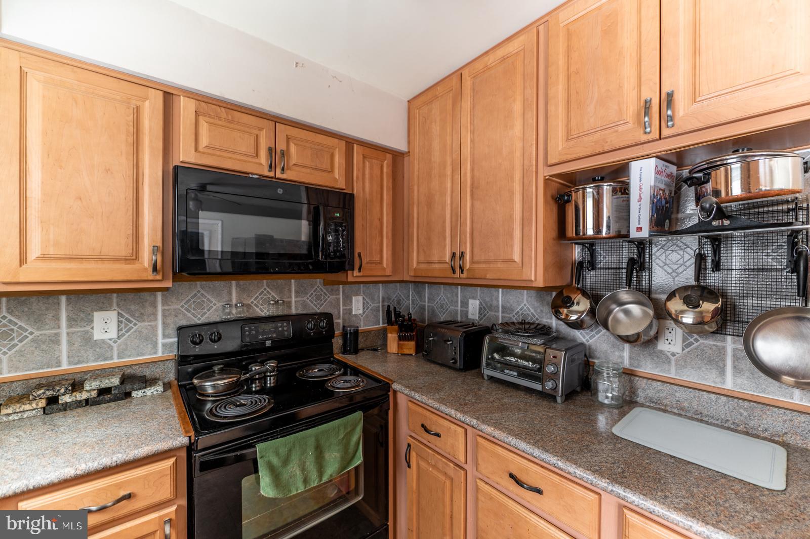 948 Quarry Road Gap, PA 17527 - Photo 12 of 34 a kitchen with stainless steel appliances granite countertop a stove a sink and a microwave