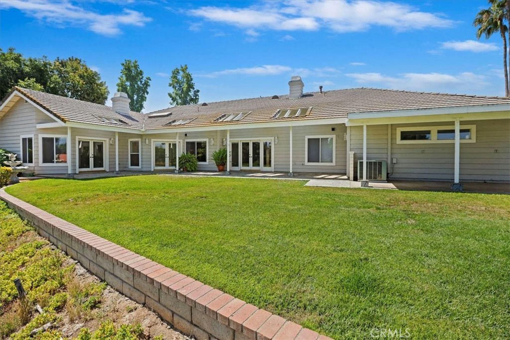 1507 Weston Way Riverside, CA 92506 - Photo 44 of 55 a front view of a house with a garden and trees