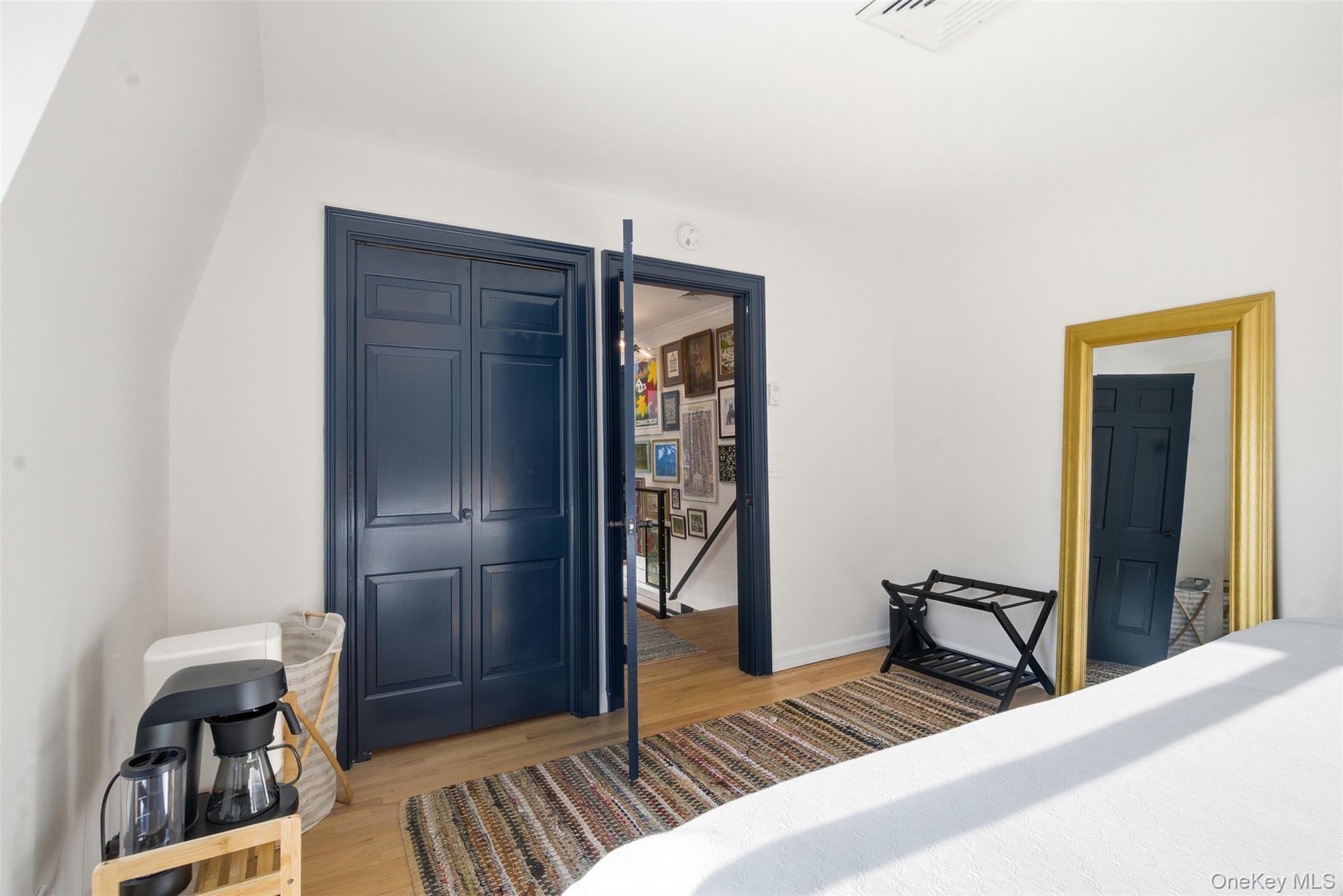 134 Fostertown Road Newburgh, NY 12550 - Photo 42 of 50 a bedroom with a bed and a bookshelf with wooden floor