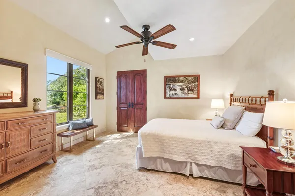 a bedroom with a large bed and a window