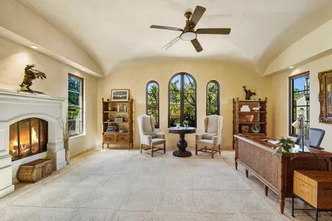 a living room with furniture and a fireplace
