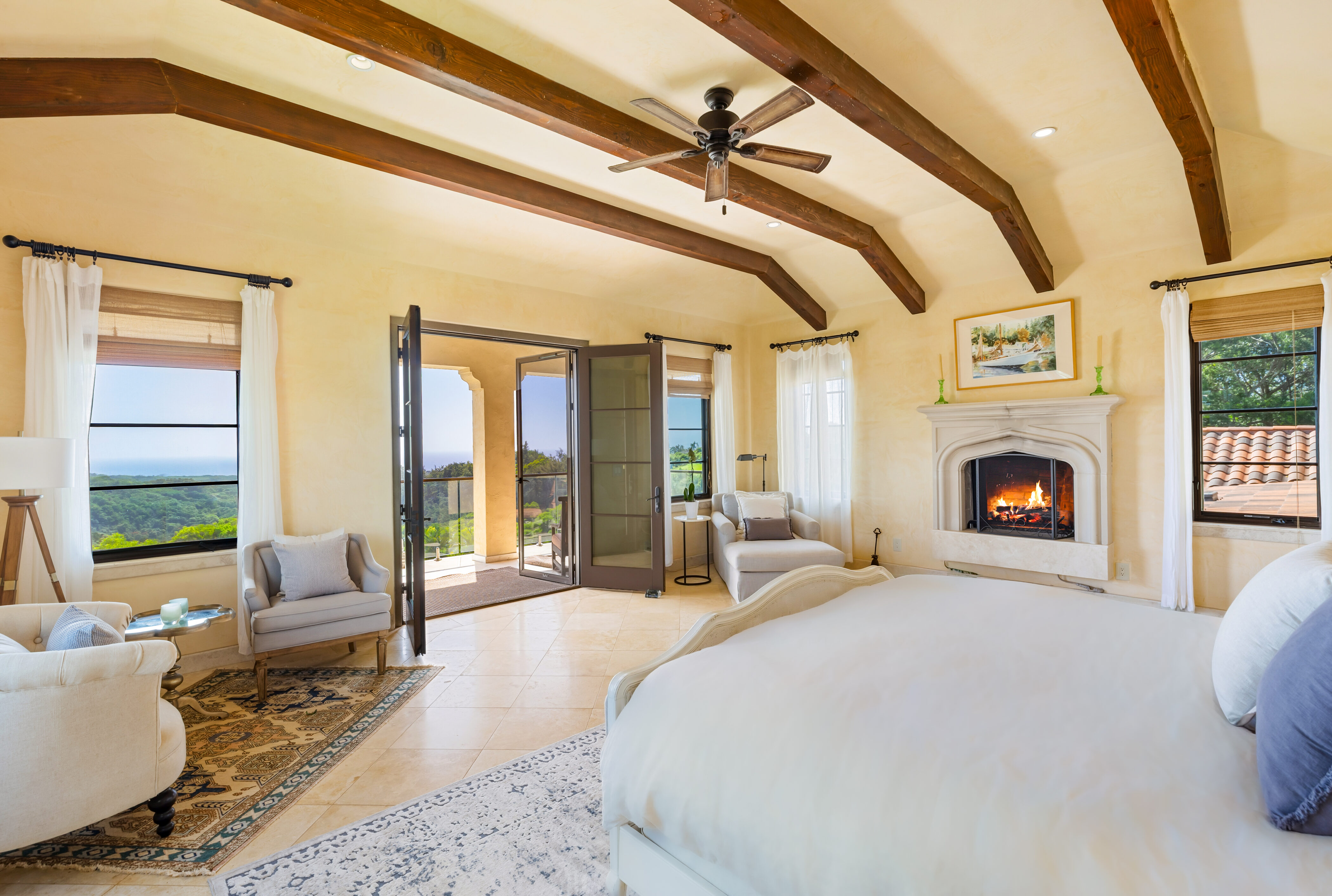 4114 Waha Road, Unit J Kalaheo, HI 96741 - Photo 20 of 30 a large bedroom with a large bed and a fireplace