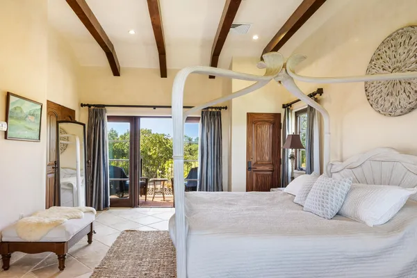 a bedroom with a bed couch and a window