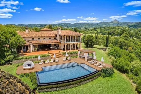 view of a house with pool and a garden