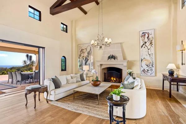 a living room with furniture a fireplace and a table