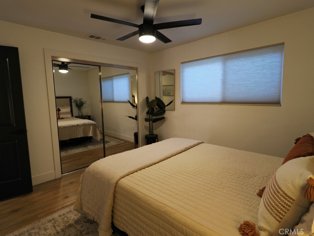28596 North Bay Road Lake Arrowhead, CA 92352 - Photo 60 of 69 a bedroom with a bed and wooden floor