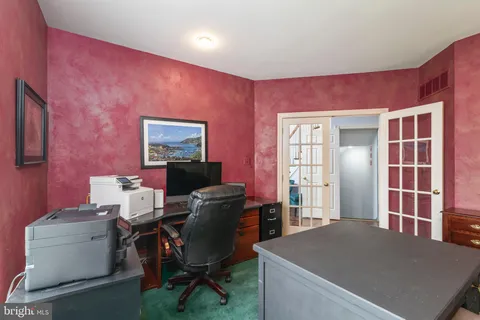 a living room with furniture a flat screen tv and a floor to ceiling window
