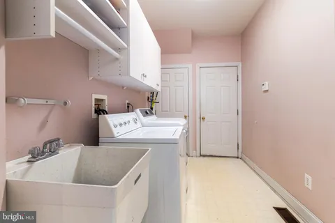 a spacious bedroom with a bed and a flat screen tv