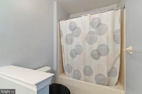 a bathroom with a sink mirror and toilet
