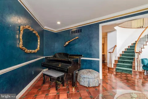 a dining room with furniture a chandelier and wooden floor