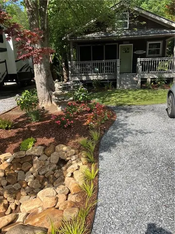 a front view of house with a garden