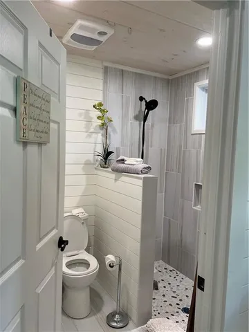 a bathroom with a toilet and a shower