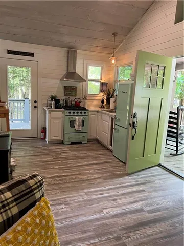a kitchen with a refrigerator and a stove