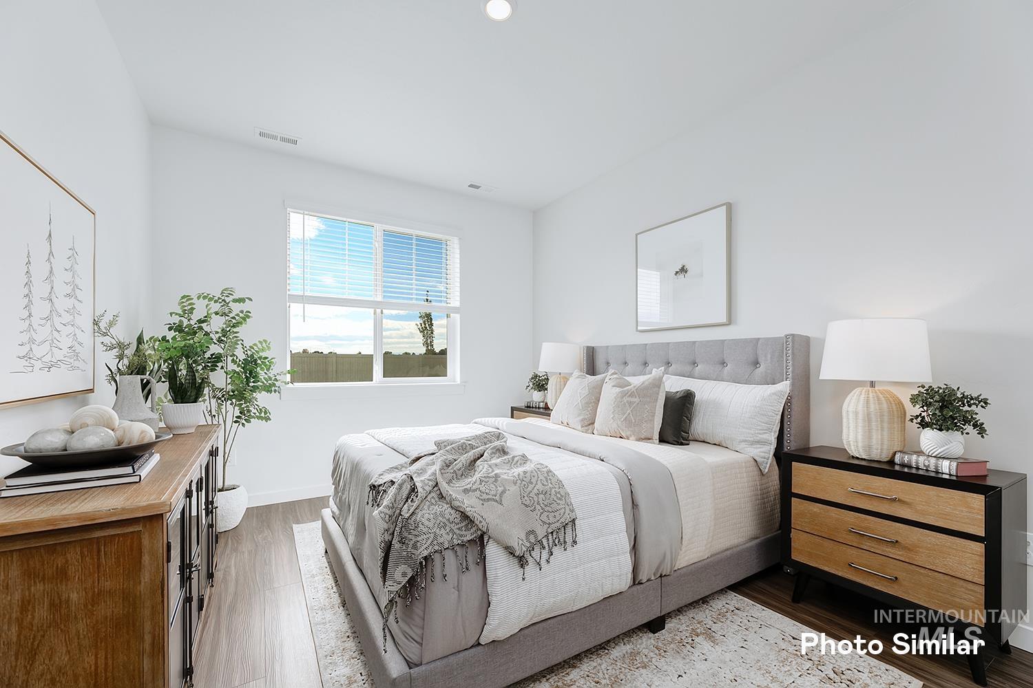 220 Ravello Street Caldwell, ID 83605 - Photo 24 of 35 Bedroom featuring dark wood finished floors and baseboards