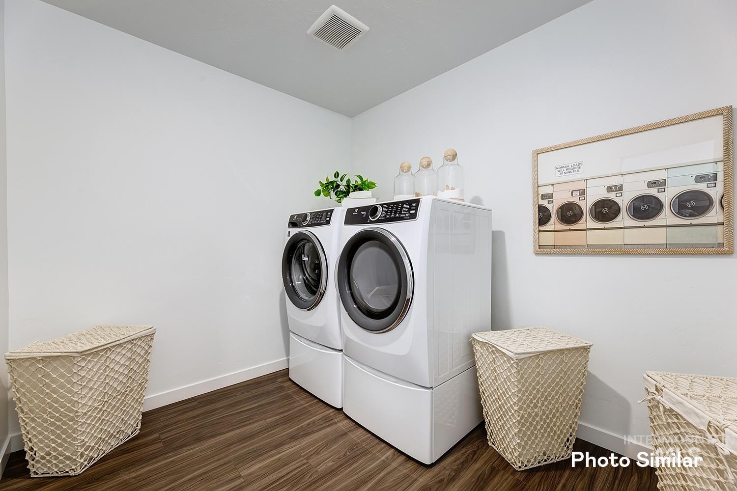 220 Ravello Street Caldwell, ID 83605 - Photo 25 of 35 Laundry area with dark wood-type flooring and independent washer and dryer