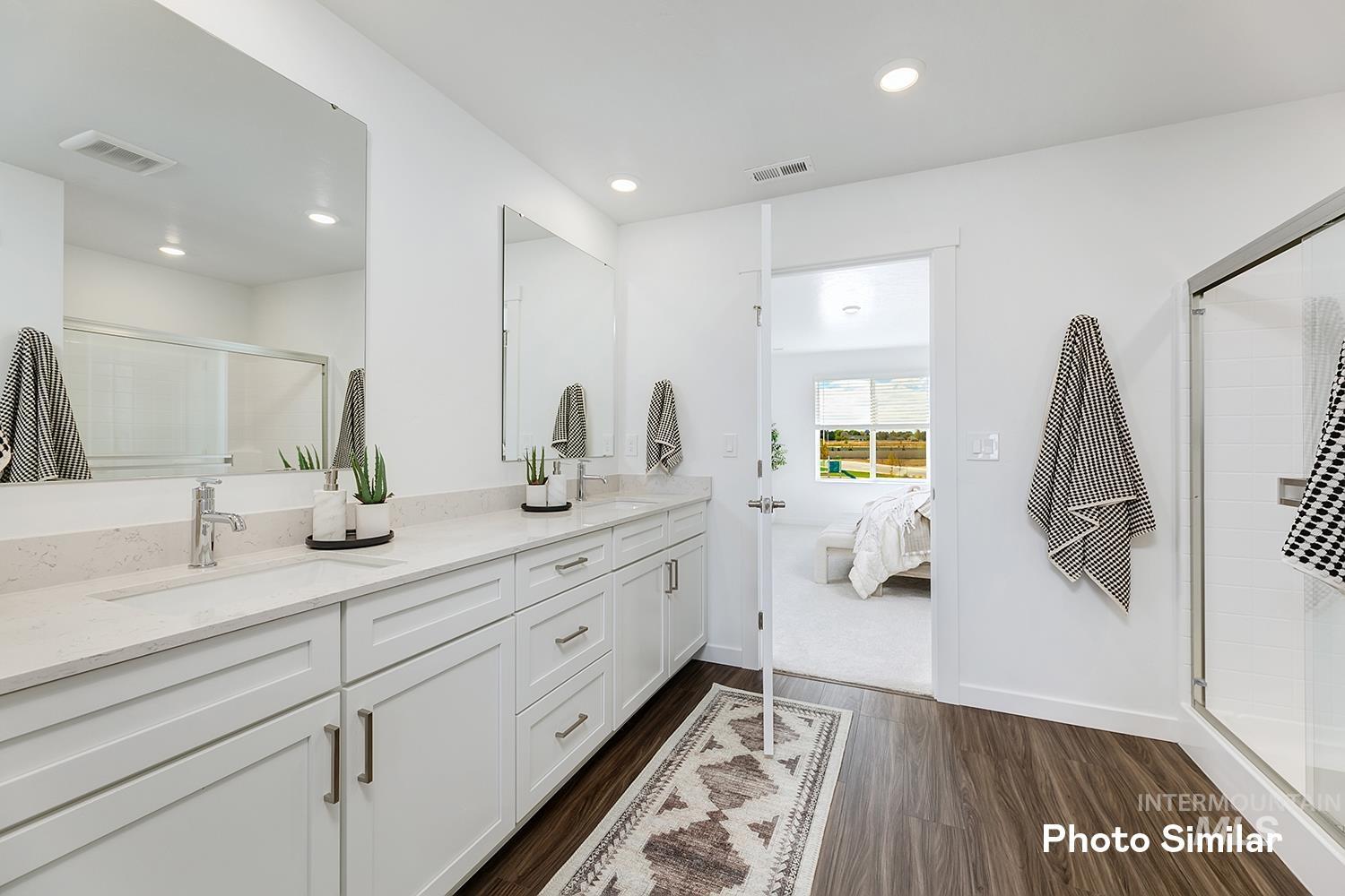 220 Ravello Street Caldwell, ID 83605 - Photo 27 of 35 Full bath with a stall shower, double vanity, dark wood-style flooring, recessed lighting, and ensuite bath