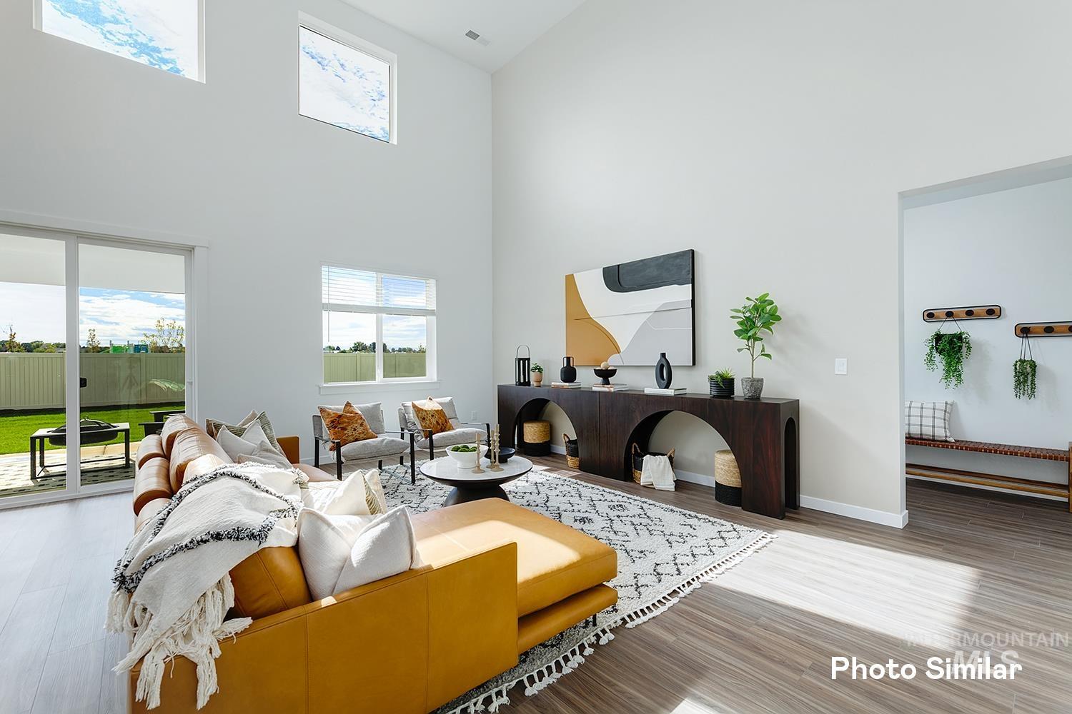 220 Ravello Street Caldwell, ID 83605 - Photo 8 of 35 Living area with a towering ceiling and wood finished floors