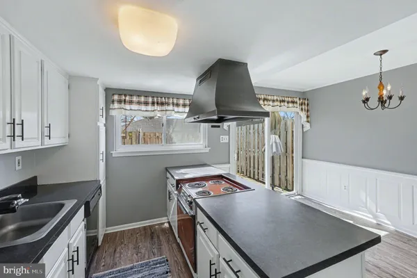 a kitchen with stainless steel appliances granite countertop a sink dishwasher stove and refrigerator