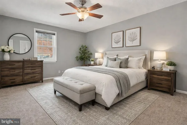 a spacious bedroom with a bed and a chandelier