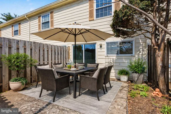a table and chairs in patio of the house
