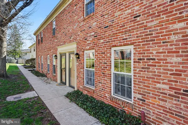 a view of a brick house with a yard