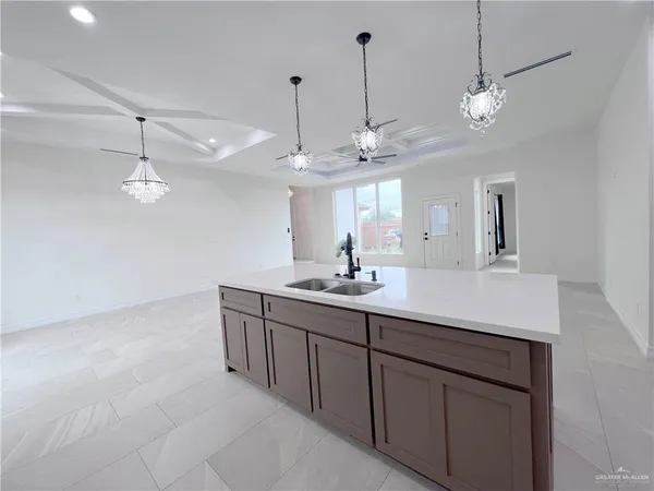 a large white kitchen with a refrigerator a stove a sink and a refrigerator