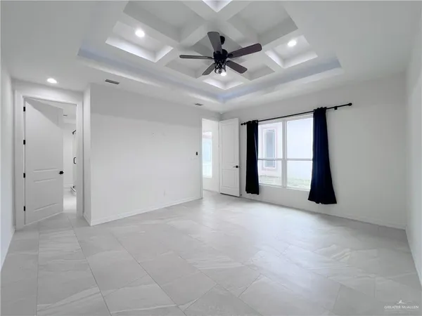 an empty room and chandelier fan