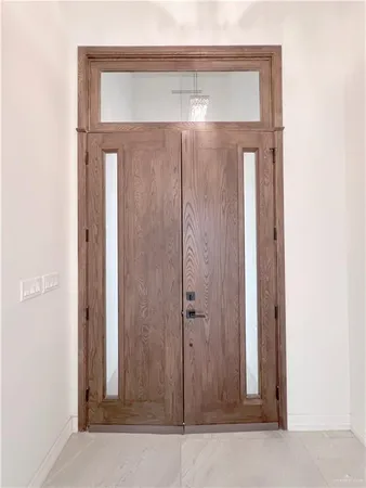 a bathroom with a glass door shower and a mirror
