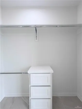 an empty room with windows and ceiling fan