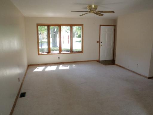 32 Marnel Road Montgomery, IL 60538 - Photo 4 of 12 an empty room with windows and chandelier