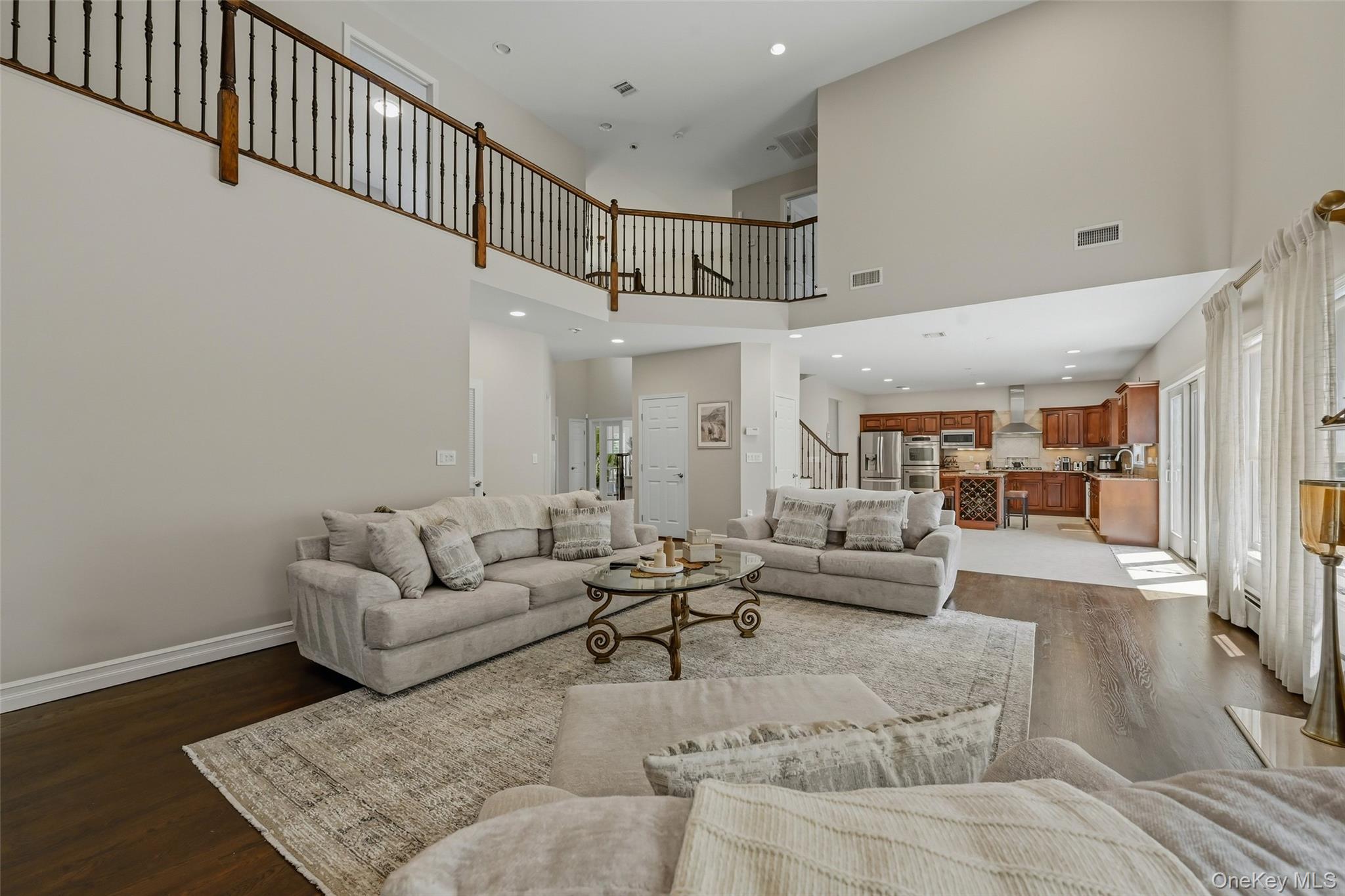 51 Meriwether Trail Congers, NY 10920 - Photo 19 of 50 Two-story living area featuring dark wood-finish flooring, a wood and iron baluster railing, and recessed lighting