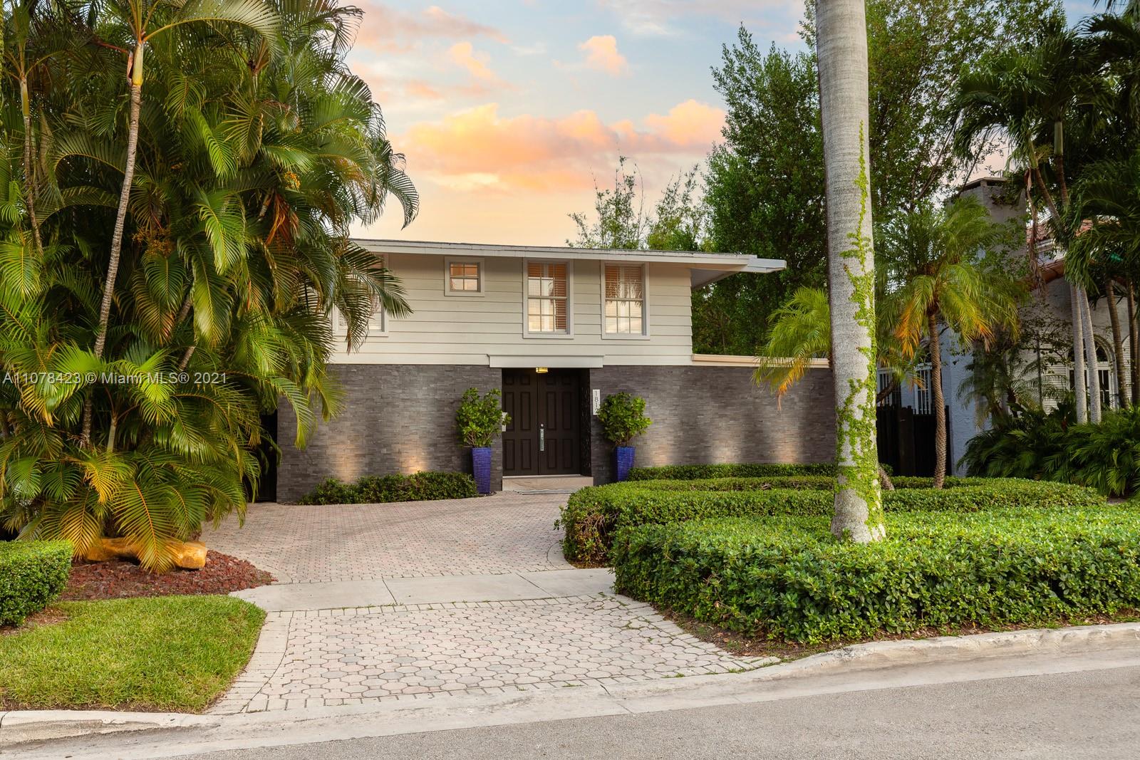 1812 Fairhaven Place Miami, FL 33133 - Photo 1 of 37 a front view of a house with a yard