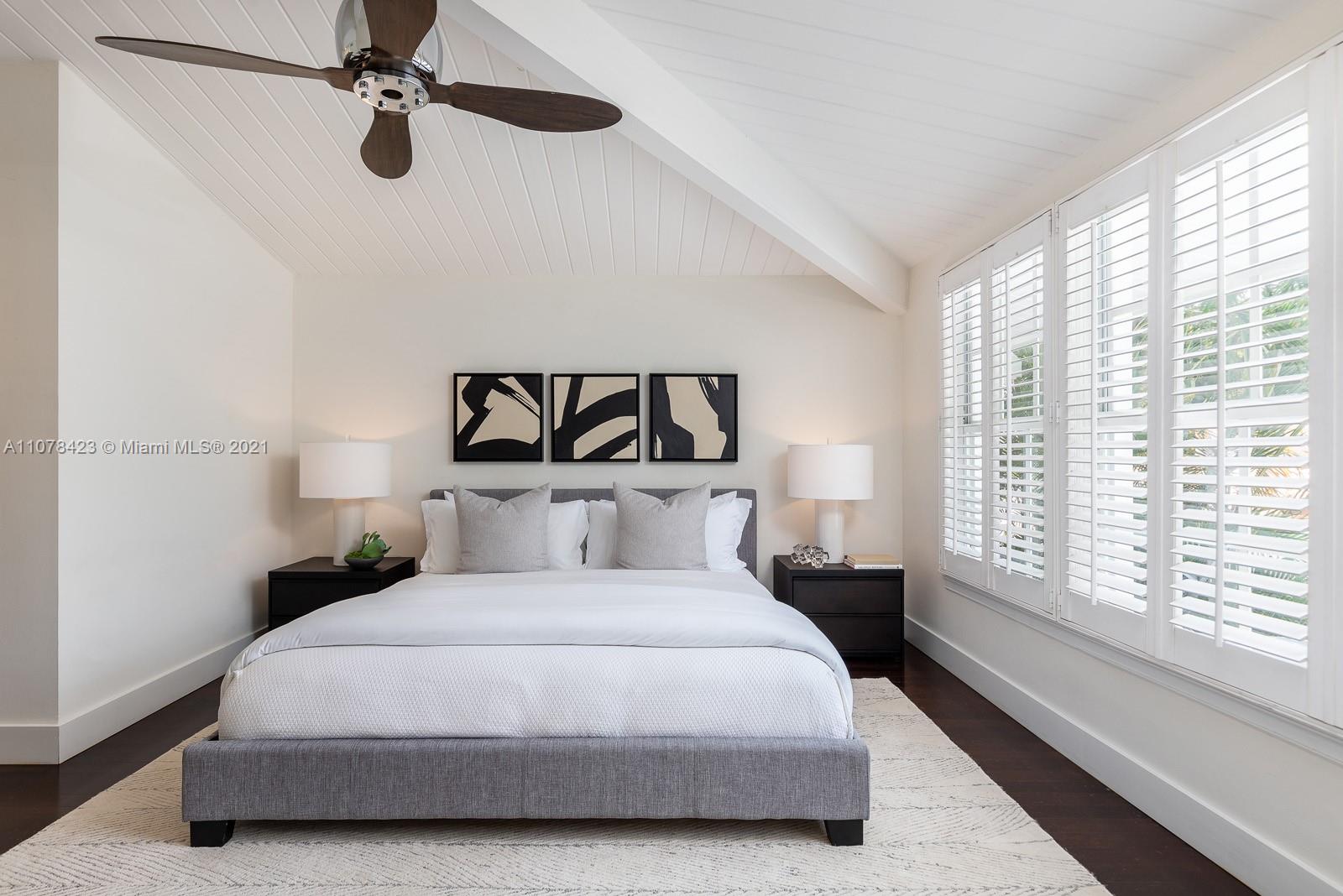 1812 Fairhaven Place Miami, FL 33133 - Photo 17 of 37 a bedroom with a large bed and a large window