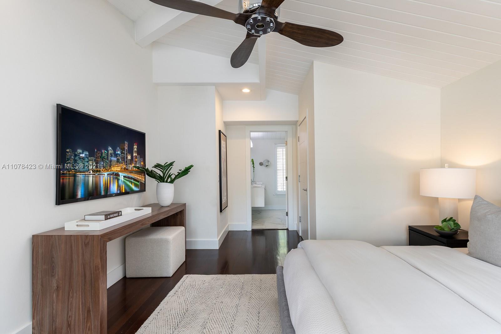 1812 Fairhaven Place Miami, FL 33133 - Photo 18 of 37 a bedroom with a bed and a flat screen tv