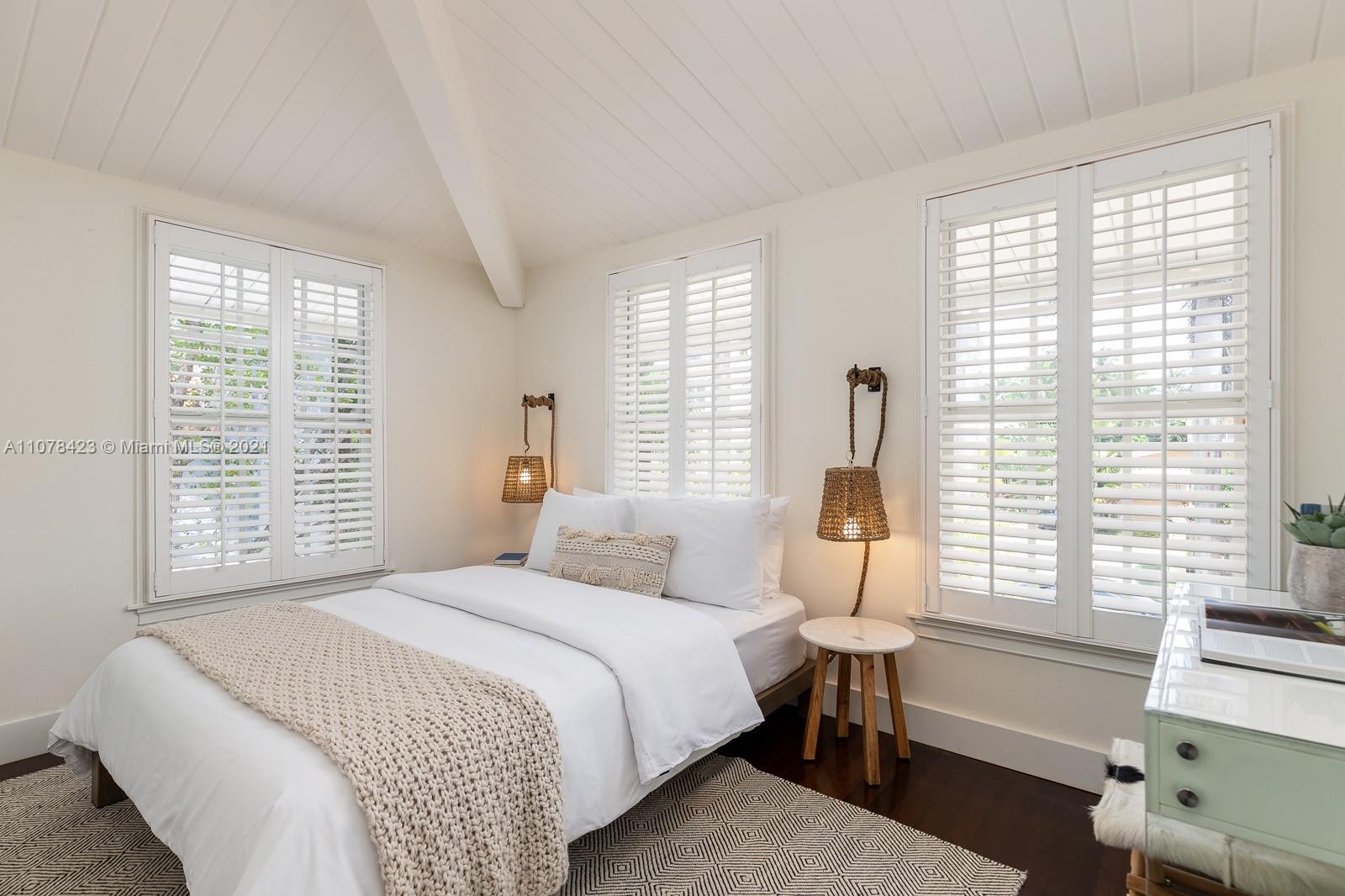 1812 Fairhaven Place Miami, FL 33133 - Photo 21 of 37 a bedroom with a bed and a table