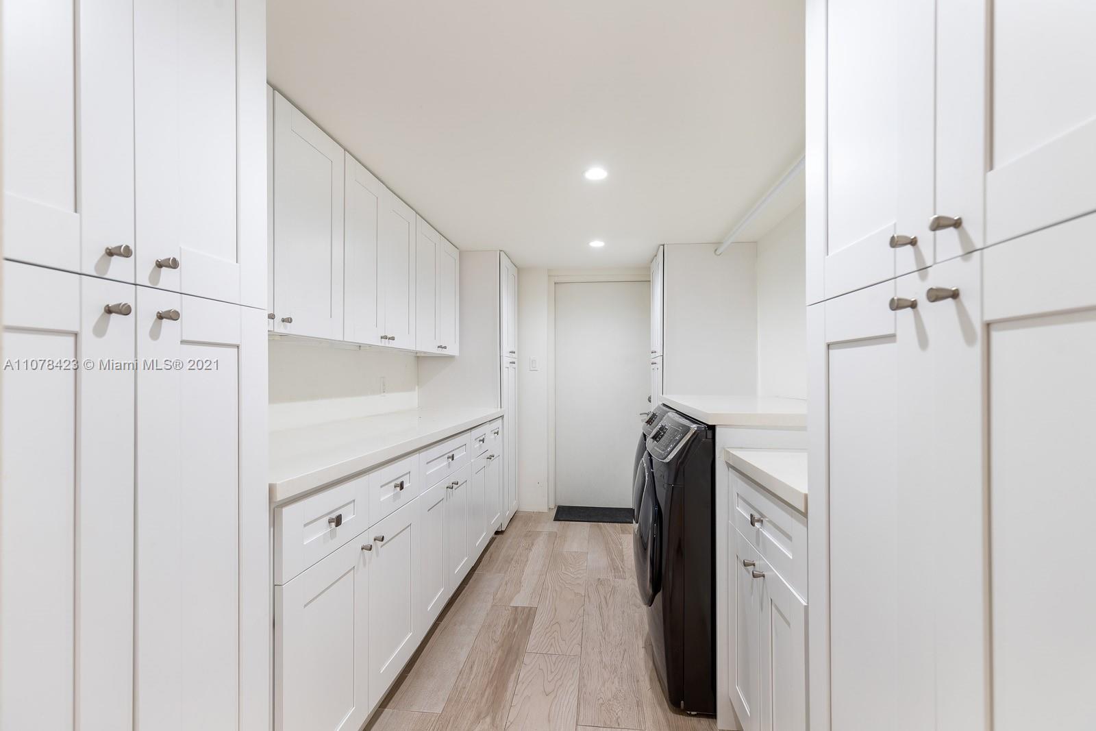 1812 Fairhaven Place Miami, FL 33133 - Photo 24 of 37 a kitchen with granite countertop cabinets and refrigerator