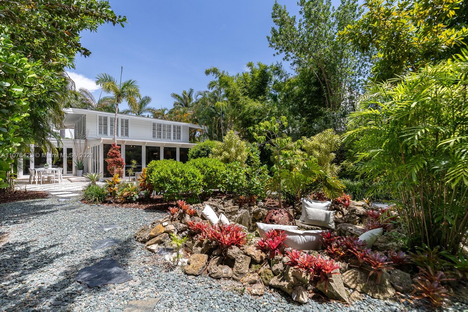 1812 Fairhaven Place Miami, FL 33133 - Photo 31 of 37 a view of a house with a yard and garden