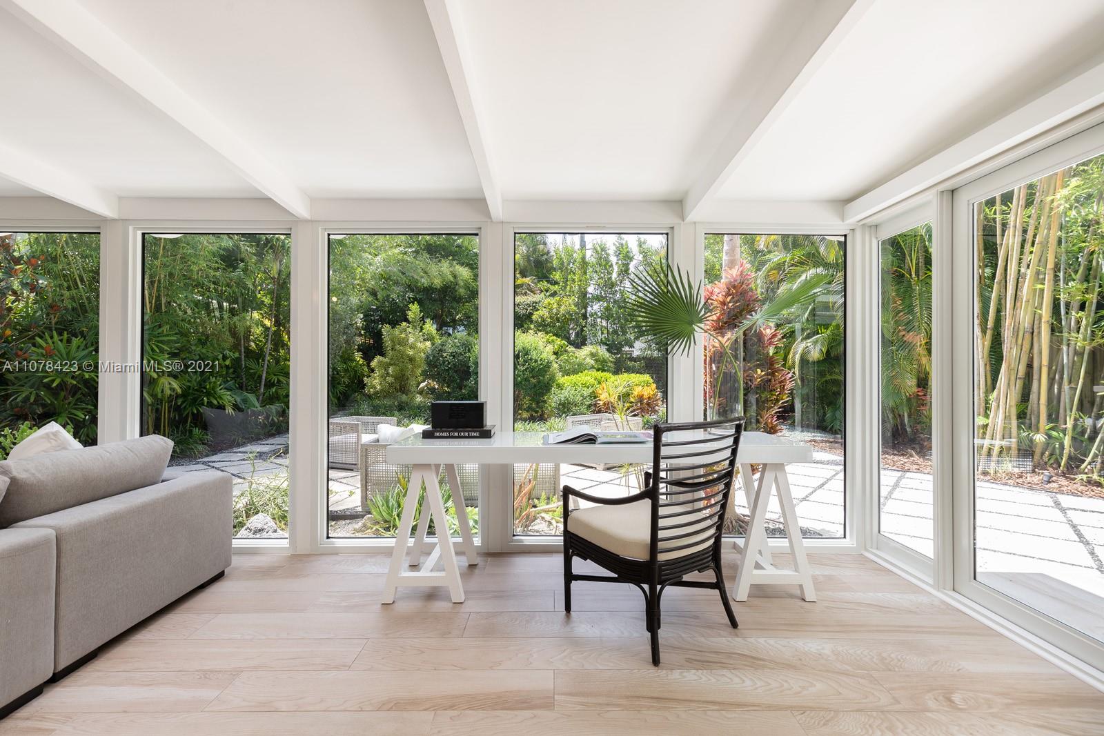 1812 Fairhaven Place Miami, FL 33133 - Photo 9 of 37 a living room with furniture and a floor to ceiling window