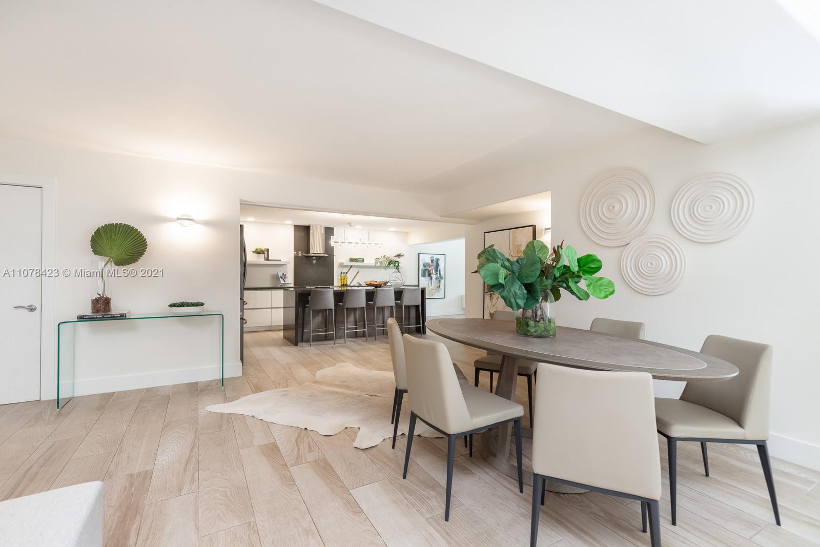 1812 Fairhaven Place Miami, FL 33133 - Photo 10 of 37 a view of a dining room with furniture and wooden floor