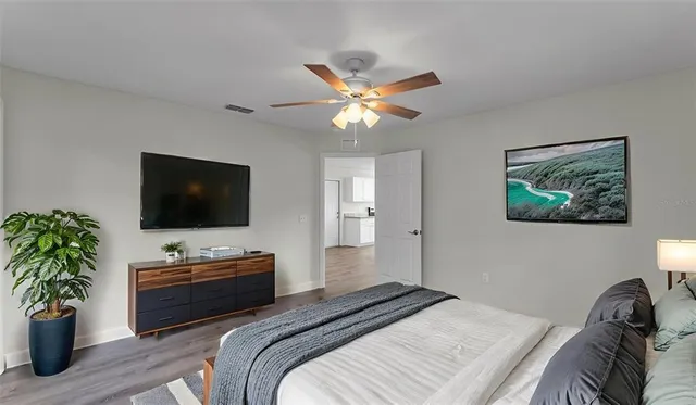 a bedroom with a bed and a television