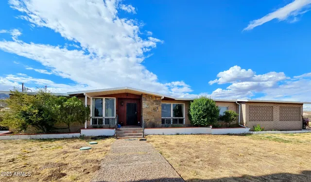 a view of a house with backyard porch and sitting area