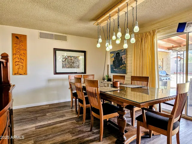 a view of a dining room with furniture and chandelier