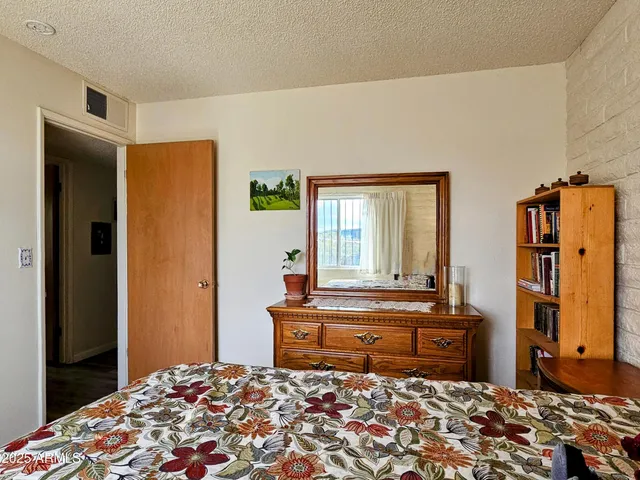 a bedroom with a bed and a dresser