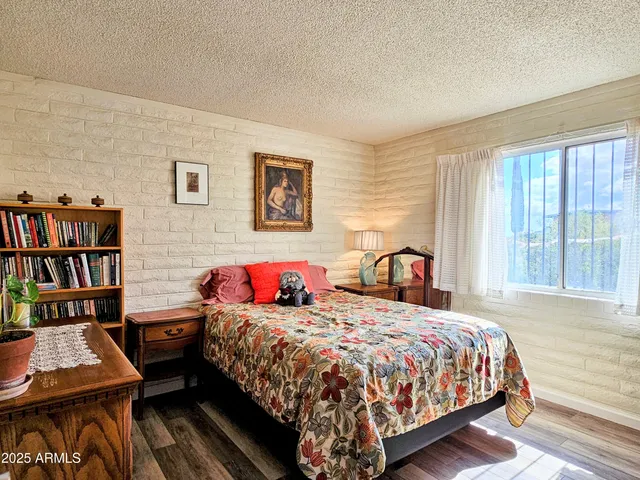 a bedroom with bed and a book shelf
