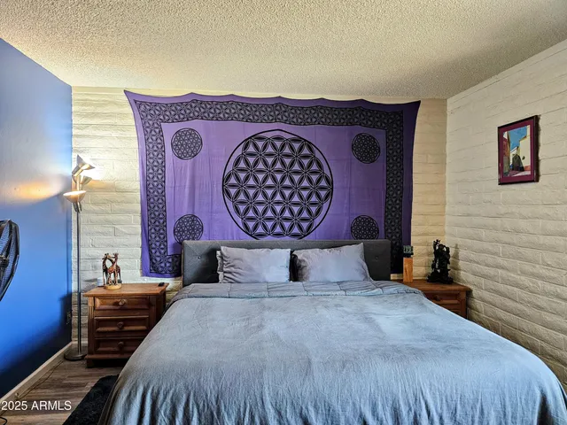 a bedroom with a bed and a mirror