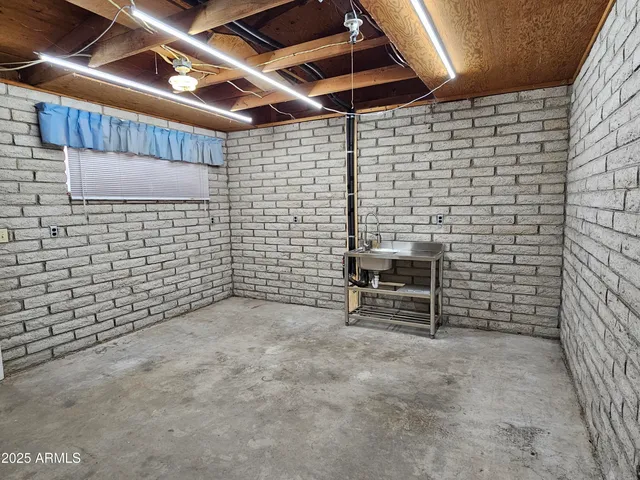 a view of empty room with brick walls