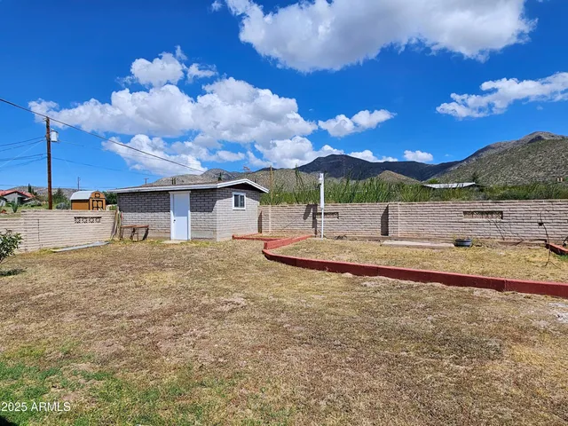 a view of a house with a backyard of the house
