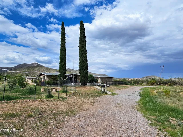 a view of a lake with a big yard and large trees